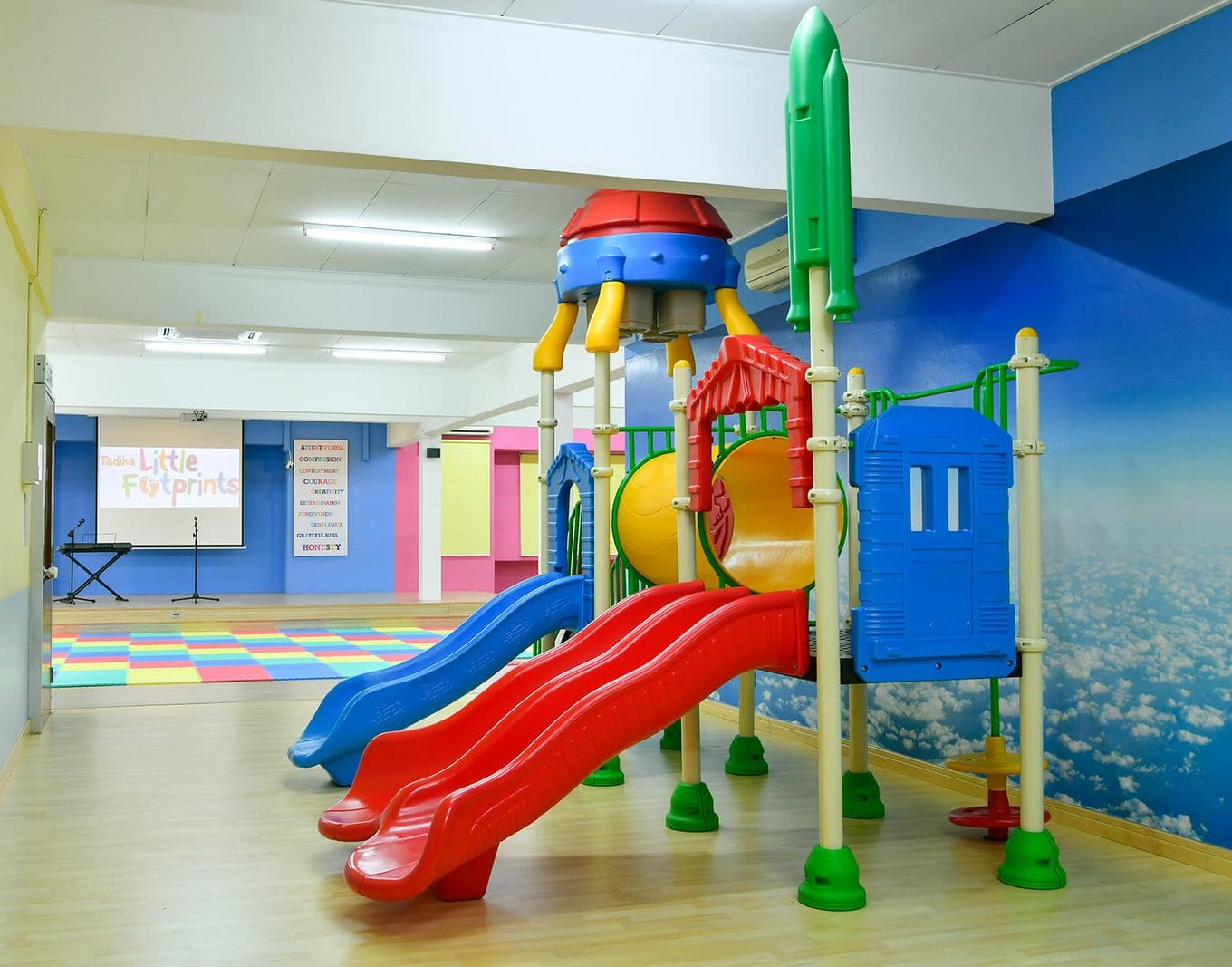 The indoor playground with a rocket climbing frame and three slides
